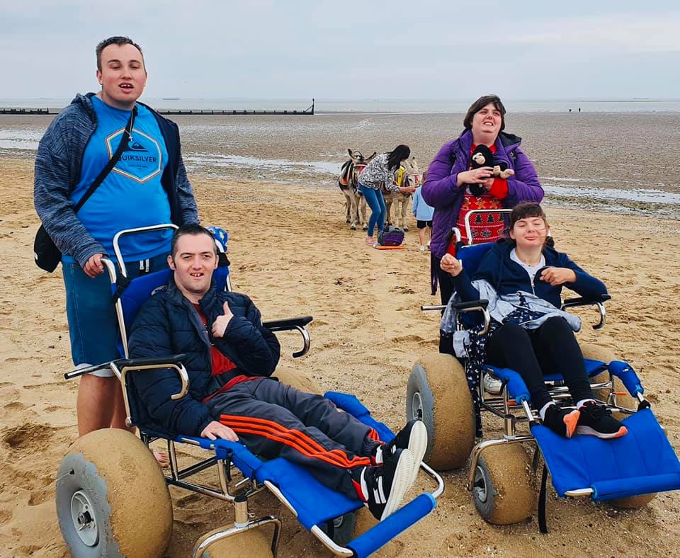 Two clients on beach wheelchairs at Cleethorpes